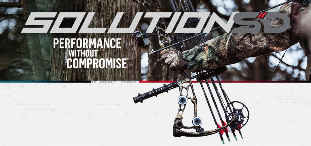 Bow hunter wearing camo clothes shooting a Bowtech Solution SD archery compound bow